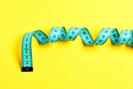 centimeter for tailor on yellow background, copy space