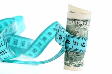 American money with tape measure isolated on white backgroundの写真素材