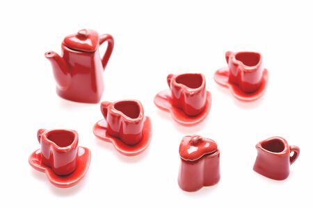 Red romantic set of tiny red heart shaped kitchenware isolated on white background, close up and selective focus. Concept of valentines day dinnerの写真素材