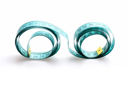 Tape for measuring unrolled wavy, isolated on white background. Symbol of diet, weight management...