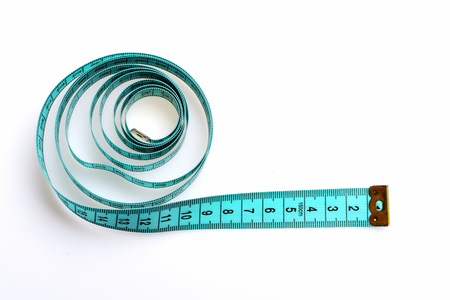 Coil of greenish blue tape for measuring with black numbers and metallic ends, isolated on white...