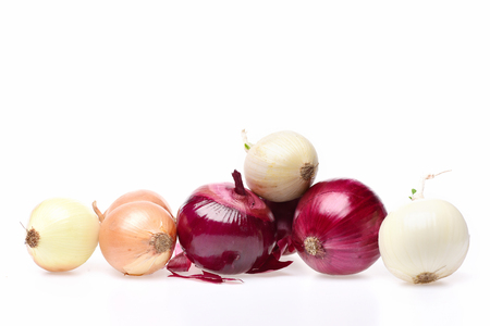 Onion soup group. Vegetables of different types holding red, yellow and white onions with a bit of dry peel isolated on white background, copy spaceの写真素材