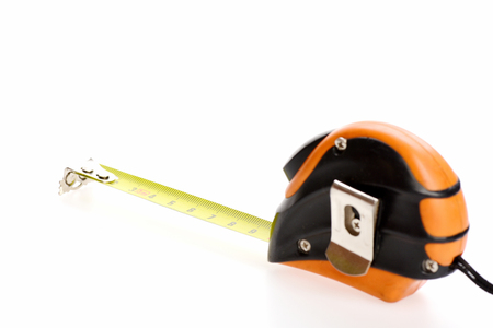 Tape measure isolated on white background with copy space. Minimalistic concept of metering and professional precisionの写真素材