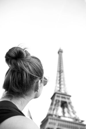 girl looking at eiffel tower in Paris, France. Black and white. Romantic travel conceptの写真素材