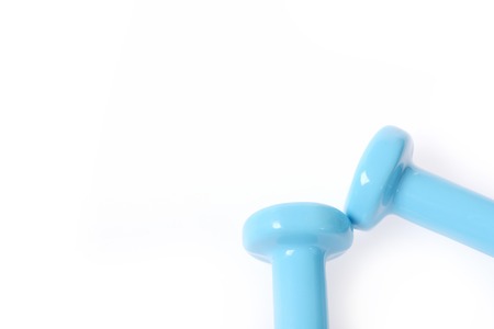 Cyan barbells frame. Angle made of turquoise dumbbells isolated on white background, copy space. Idea of sports and shapingの写真素材