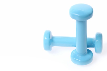 Concept of fitness and sports with pair of cyan dumbbells isolated on white background, close up and copy spaceの写真素材