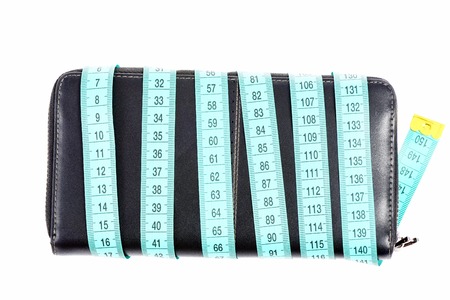 Phone cover of black color wrapped with light cyan tape for measuring isolated on white background, top view. Concept of fashion and budgetの写真素材