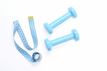 Slim shape equipment. Tape for measuring in blue color near cyan lightweight barbells isolated on...