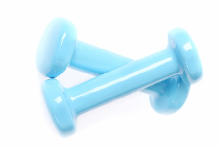 Crossed cyan dumbbells isolated on white background, representing concept of working out and doing sportsの写真素材