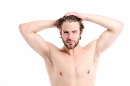 Morning time and sportive shape concept. Man with naked torso, confident face, beard and wet hair touches his head. Macho with big muscles and strong body isolated on white backgroundの写真素材