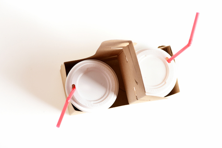 Paper cups with fizzy drinks, plastic lids and red straws in eco carton package isolated on white background, top view. Concept of fastfood and drink for twoの写真素材