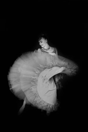 girl or woman in dress on black background, pretty female dancer. Black and white