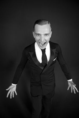 screaming young business man. crisis concept. angry businessman in tuxedoの写真素材