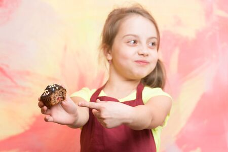 Small girl on colorful background with cupcake.の写真素材