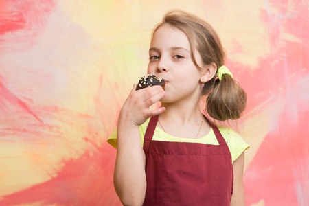 Chef child with cupcake on colorful background.の写真素材