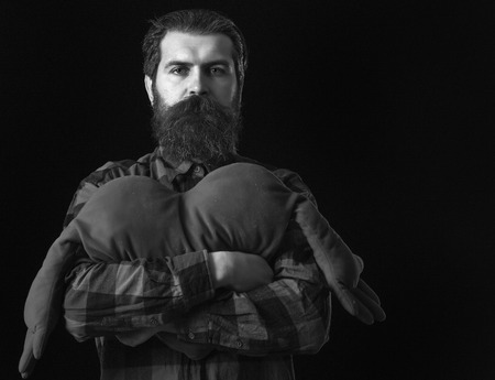 handsome bearded man or guy in checkered shirt with fashionable mustache and beard on serious face...