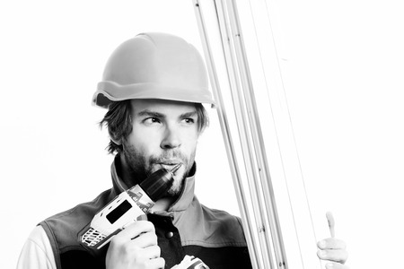 Builder in orange helmet and uniform. Work in progress and repairing concept. Construction worker...