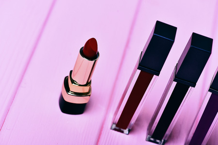 set of various various lipsticks on pink wooden background, side view, selective focusの写真素材