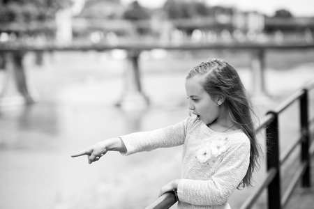Portrait of a lovely little happy cute princess girl with long blonde curly hair at summer sunny dayの写真素材