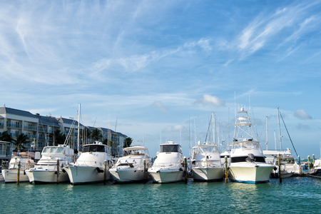 Yachts moored at sea pier on sunny day on blue sky background in Key West, USA. Summer vacation, travel and adventure. Yachting and sailing. Luxury and active lifestyle conceptのeditorial素材