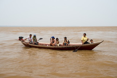 Boca de valeria, Brazil - December 03, 2015: people rowing in boat on brown water surface on grey sky. Travel and travelling concept.のeditorial素材