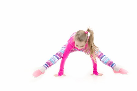 Fitness and health. Child in pink sportswear. Workout of small girl isolated on white background. Sport and success. Education and energy, sportの写真素材