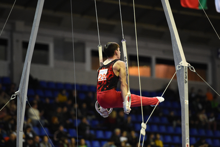 Kyiv. Ukraine-April 1, 2017 : Male gymnast performing on stationary gymnasic rings during Stella Zakharova Artistic Gymnastics Cupのeditorial素材