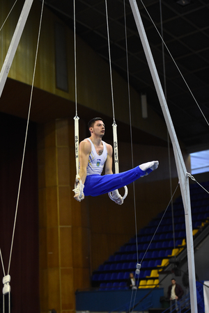 Kyiv. Ukraine-April 1, 2017 : Male gymnast performing on stationary gymnasic rings during Stella Zakharova Artistic Gymnastics Cupのeditorial素材