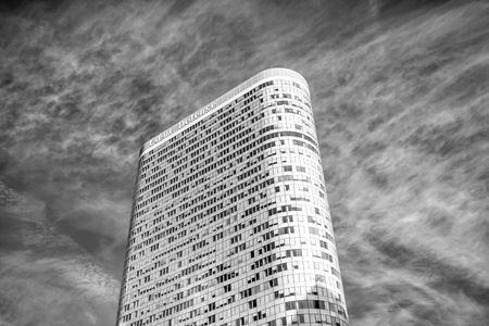 La Defense, France - September 23, 2017: tower building with glass windows on rounded walls facade on cloudy sky. Architecture, design, structure concept, black and whiteのeditorial素材