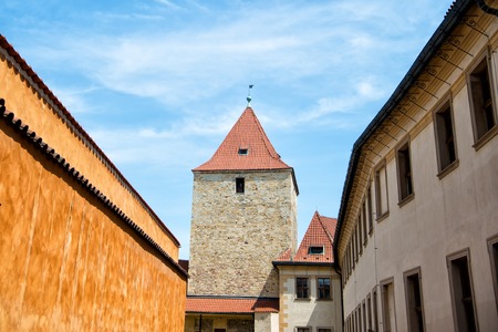 Tower and fortification wall in Prague, Czech Republic, on sunny day on blue sky background. Travelling, wanderlust, vacation concept.の写真素材