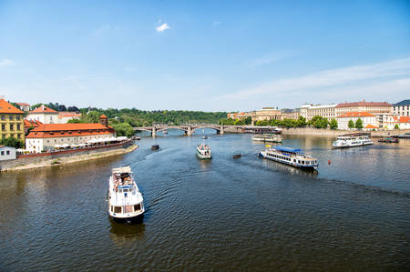 Prague, Czech Republic - June 03, 2017: river cruise ships along city center landmarks and panorama on sunny day on blue sky background. Tourist destination, vacation, travelling conceptのeditorial素材