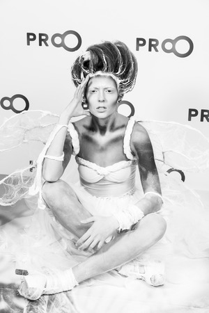 Kyiv, Ukraine - September 16, 2015: girl model with hair performs professional makeup and body art on masterclass at International exhibition of perfumery and cosmetics Intercharm as animal in whiteのeditorial素材