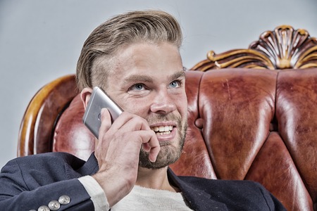 Man or businessman smile and talk on mobile phone on sofa. Business communication concept....