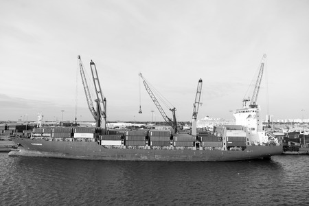 March 18, 2016: Large orange cargo ship Glucksburg Docked at the por of Miami, Florida, USAのeditorial素材