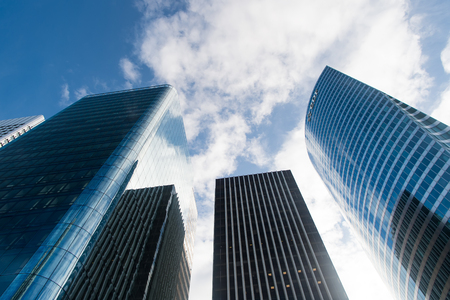 Paris, France - September 30, 2017 :Tower buildings of steel cladding and glass windows on cloudy blue sky in district of la defense, paris, france. Architecture, future, business conceptのeditorial素材
