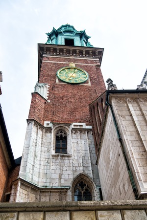Clock tower in krakow, poland on grey sky. Time, past concept.