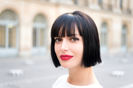 Woman or girl with red lips, makeup face, brunette hair pose in paris, france. Beauty, look, visage conceptの写真素材