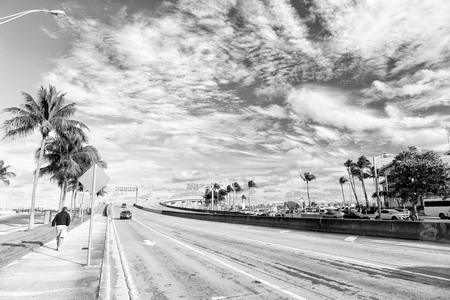 miami highway or public road roadway for transport vehicles and urban skyscrapers on cloudy blue sky background next to the port, miami dadeの写真素材