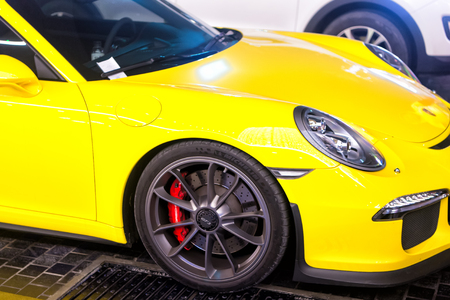 DUBAI, UAE - december 23, 2017: luxury Supercar Porsche 911 Carrera 4 GTS yellow color parked next to Dubai mall. Lamborghini is famous expensive automobile brand carのeditorial素材