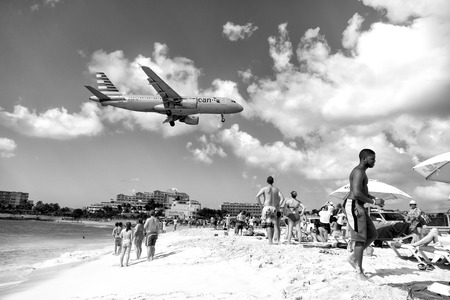 St Maarten, Netherlands - February 13, 2016: beach observe low flying airplanes landing near Maho Beach on island of St Maarten in the Caribbeanのeditorial素材