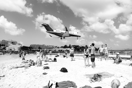 St Maarten, Netherlands - February 13, 2016: beach observe low flying airplanes landing near Maho Beach on island of St Maarten in the Caribbeanのeditorial素材