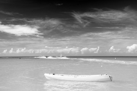 Bright view of exotic colorful beautiful marine beach of Antigua St. Johns with yellow boat on blue water and sky with small clouds in sunny weather outdoor onの写真素材