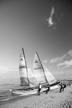 Gdansk, Poland - September 19, 2016: windsurfer or man sportsman surfs and sails on board by wind on sea water waves surface inshore on sunny day on blue skyのeditorial素材