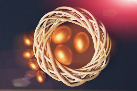 happy easter egg. holiday bunny and eggs, spring flower backround Happy Easter decorative golden eggs inside woven wooden wreath nest isolated on black background. Family celebration concept, top viewの写真素材