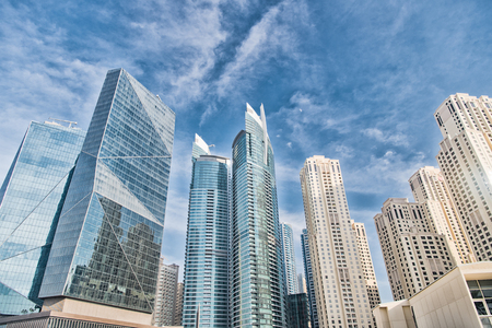 Skyscrapers in Dubai, United Arab Emirates, bottom view. Modern building on blue sky. Cityscape, skyline, urban background. Architecture, structure, design. Future, success, development.の写真素材