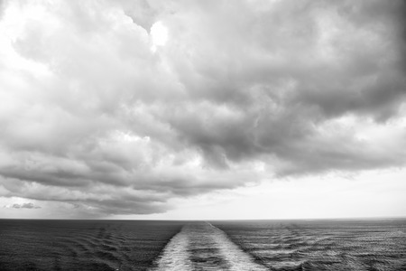 trace of ship on water with cloudy sky as natural backgroundの写真素材