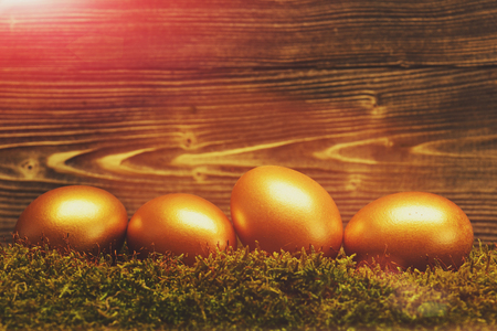 happy easter holidays egg golden decoration, traditional eggs painted in gold metallic color on wooden background, happy easter, luxury and success, riches and treasure, retirement, antique artの写真素材
