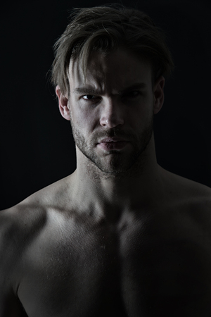 Sexy macho with bare chest muscles, sport. Man with bearded face skin and stylish hair, beauty. Mens beauty, skincare. Sport, fitness, bodybuilding concept. Bodycare or wellness and healthの写真素材