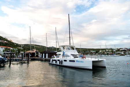 Philipsburg, Sint Maarten - January 24, 2016: yacht anchored at sea pier. People sit on modern ship deck. Luxury travel on yacht, wanderlust. Summer vacation at Caribbean. Water transport and vessel.のeditorial素材
