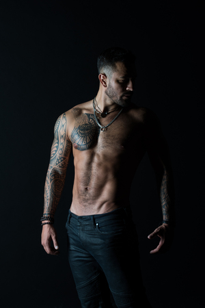 He got perfect torso. Tattoo man with sexy bare torso in jeans. Bearded macho with tattooed body. Athlete with sexy bare torso in jeans. Sportsman with muscular chest and belly. Sport and fitness.の写真素材